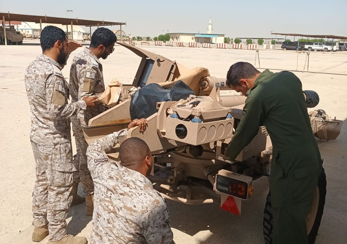Military men working on vehicle